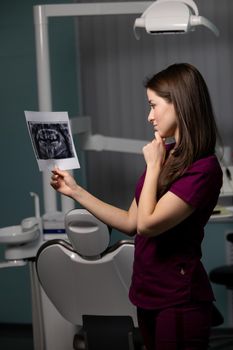 beautiful woman doctor with dental scans in hands in a dental clinic. High quality photo