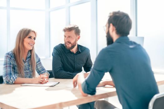 group of business people sitting at the office table. the concept of employment