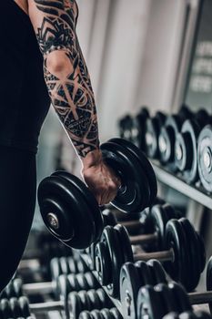 close up.dumbbell in the hand of a bodybuilder