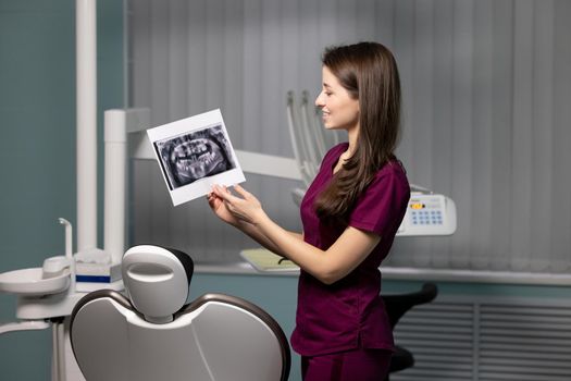 beautiful woman doctor with dental scans in hands in a dental clinic. High quality photo