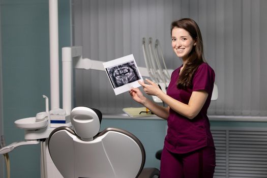 beautiful woman doctor with dental scans in hands in a dental clinic. High quality photo