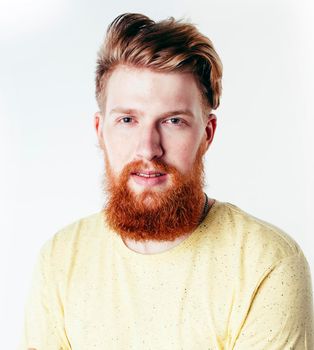 young handsome hipster ginger bearded guy looking brutal isolated on white background, lifestyle people concept close up