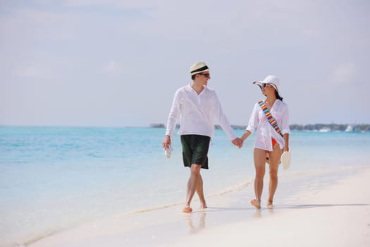 happy young romantic couple in love have fun running and relaxing on beautiful beach