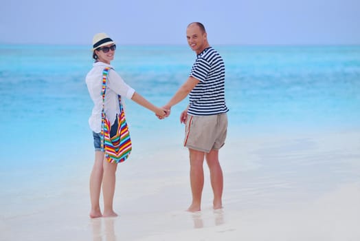 happy young romantic couple in love have fun running and relaxing on beautiful beach