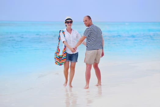 happy young romantic couple in love have fun running and relaxing on beautiful beach