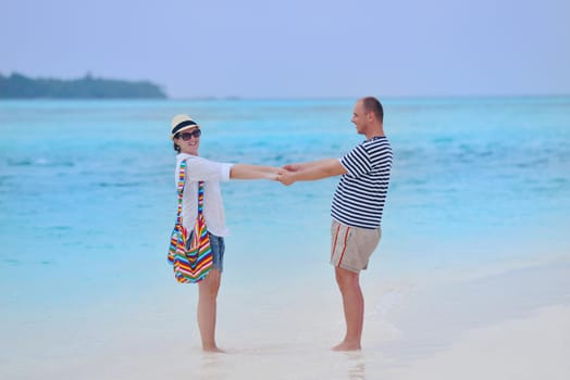 happy young romantic couple in love have fun running and relaxing on beautiful beach