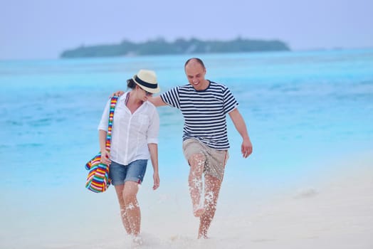 happy young romantic couple in love have fun running and relaxing on beautiful beach