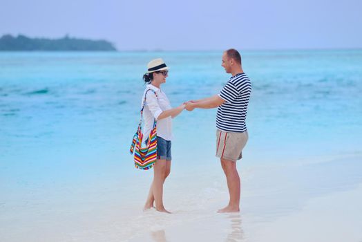 happy young romantic couple in love have fun running and relaxing on beautiful beach