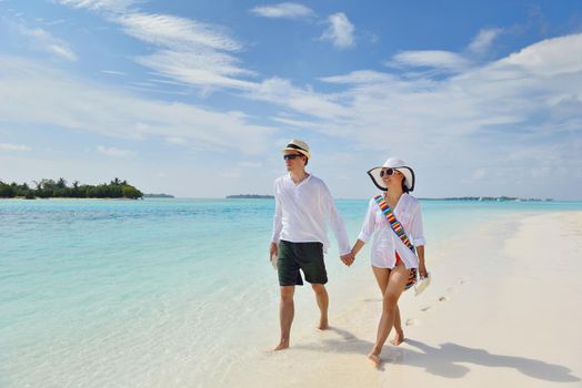 happy young romantic couple in love have fun running and relaxing on beautiful beach