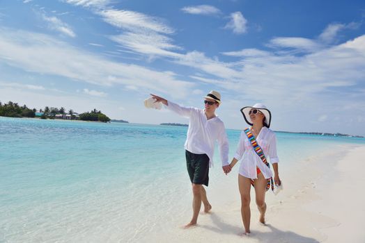 happy young romantic couple in love have fun running and relaxing on beautiful beach