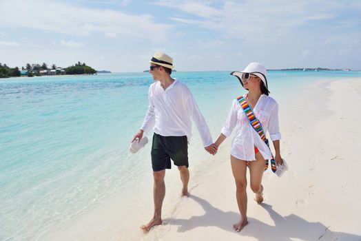 happy young romantic couple in love have fun running and relaxing on beautiful beach