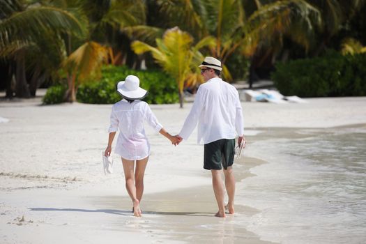 happy young romantic couple in love have fun running and relaxing on beautiful beach