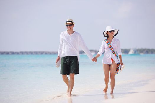 happy young romantic couple in love have fun running and relaxing on beautiful beach