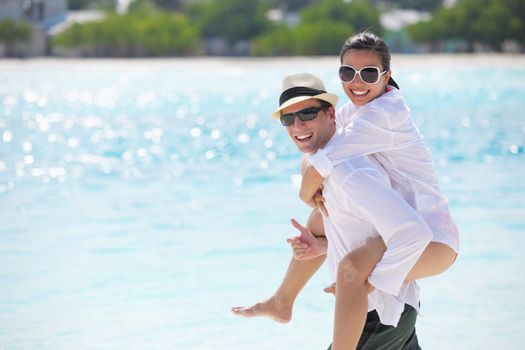 happy young romantic couple in love have fun running and relaxing on beautiful beach