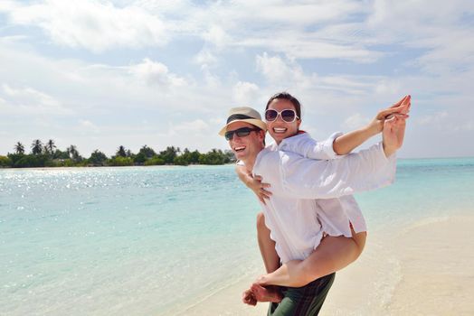 happy young romantic couple in love have fun running and relaxing on beautiful beach