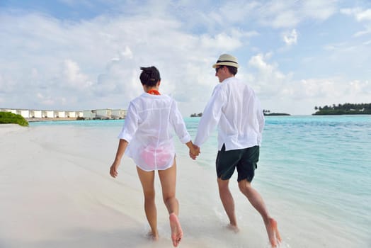 happy young romantic couple in love have fun running and relaxing on beautiful beach