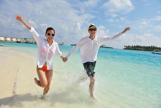 happy young romantic couple in love have fun running and relaxing on beautiful beach