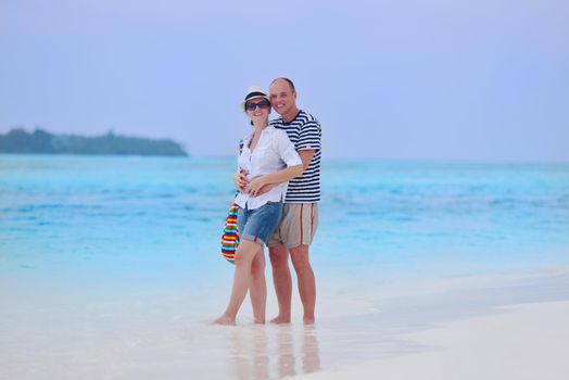 happy young romantic couple in love have fun running and relaxing on beautiful beach