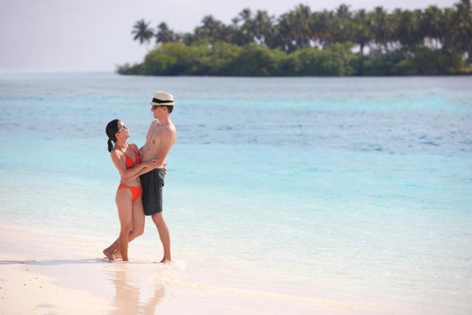 happy young romantic couple in love have fun running and relaxing on beautiful beach