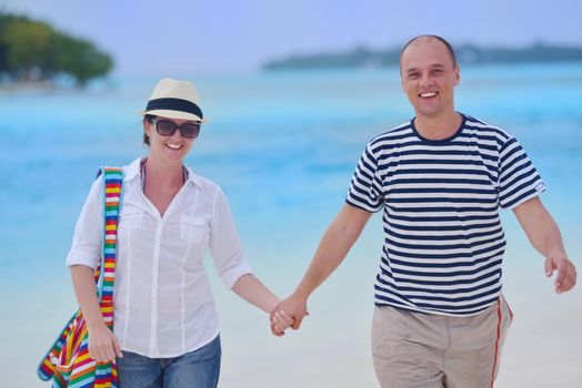 happy young romantic couple in love have fun running and relaxing on beautiful beach