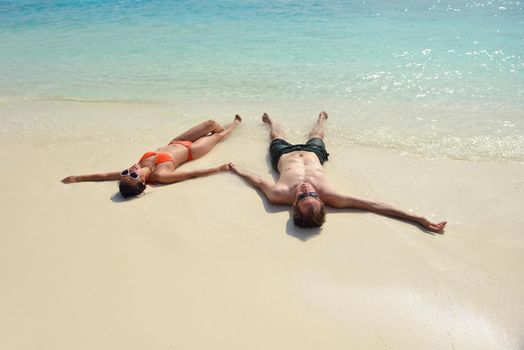 happy young romantic couple in love have fun running and relaxing on beautiful beach