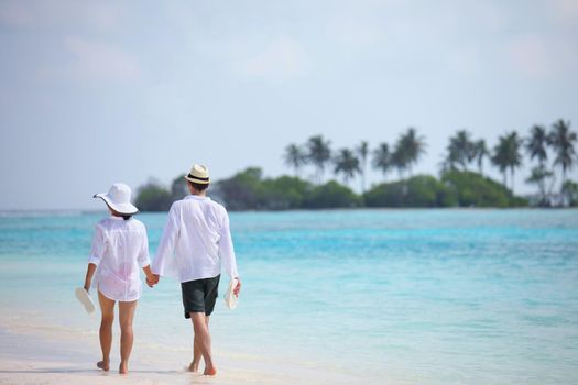 happy young romantic couple in love have fun running and relaxing on beautiful beach