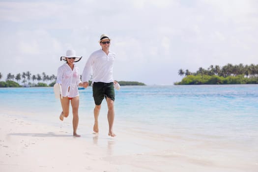 happy young romantic couple in love have fun running and relaxing on beautiful beach