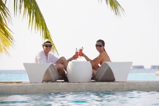 happy young couple relax and take fresh drink at summer vacation