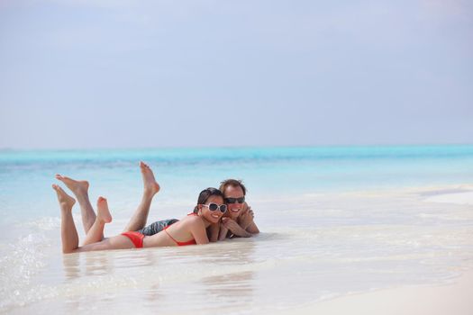 happy young romantic couple in love have fun running and relaxing on beautiful beach