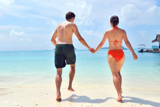 happy young romantic couple in love have fun running and relaxing on beautiful beach