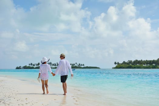 happy young romantic couple in love have fun running and relaxing on beautiful beach