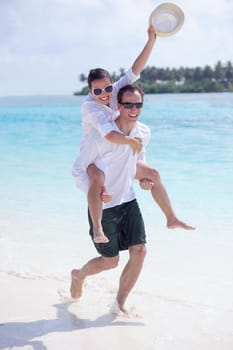 happy young romantic couple in love have fun running and relaxing on beautiful beach