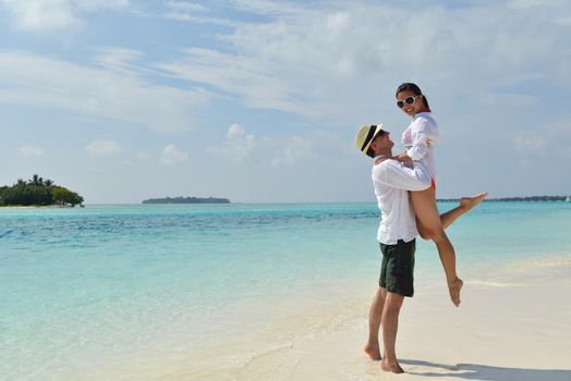 happy young romantic couple in love have fun running and relaxing on beautiful beach