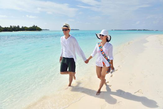 happy young romantic couple in love have fun running and relaxing on beautiful beach