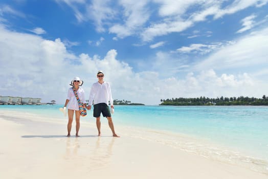 happy young romantic couple in love have fun running and relaxing on beautiful beach