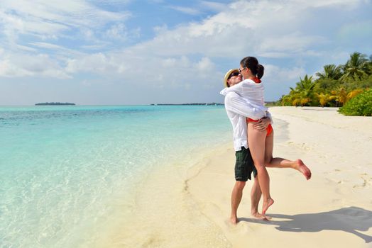 happy young romantic couple in love have fun running and relaxing on beautiful beach