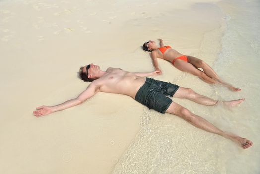 happy young romantic couple in love have fun running and relaxing on beautiful beach