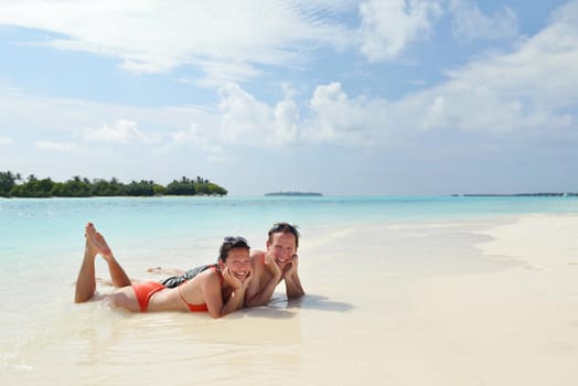 happy young romantic couple in love have fun running and relaxing on beautiful beach