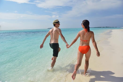 happy young romantic couple in love have fun running and relaxing on beautiful beach