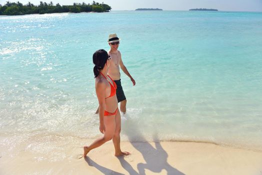 happy young romantic couple in love have fun running and relaxing on beautiful beach