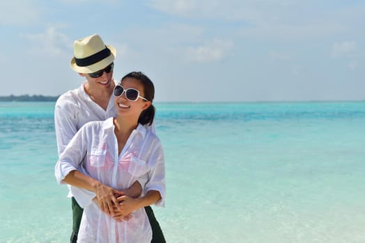 happy young romantic couple in love have fun running and relaxing on beautiful beach