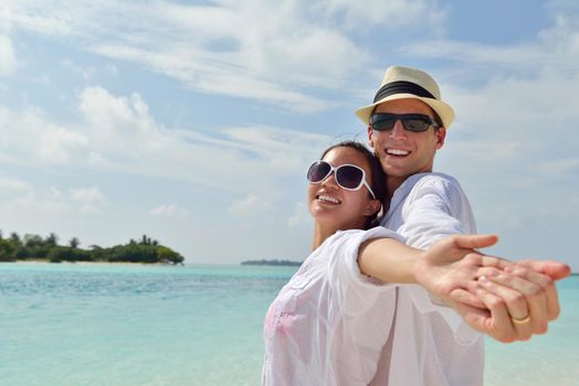 happy young romantic couple in love have fun running and relaxing on beautiful beach