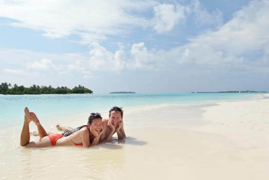 happy young romantic couple in love have fun running and relaxing on beautiful beach