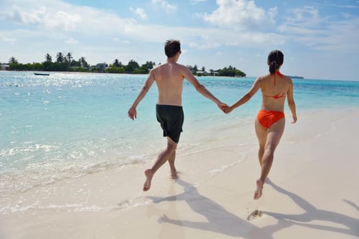 happy young romantic couple in love have fun running and relaxing on beautiful beach