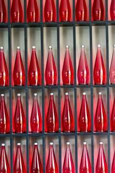 abstract background of decorative bottles of red juice in modern restaurant