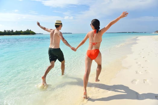 happy young romantic couple in love have fun running and relaxing on beautiful beach