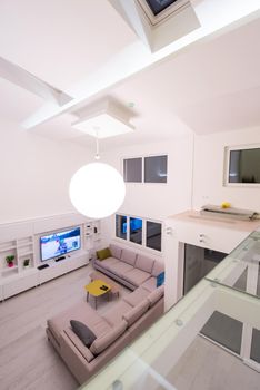 interior of a luxury stylish modern open space design two level apartment with white walls