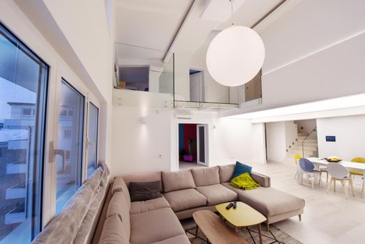 interior of a luxury stylish modern open space design two level apartment with white walls