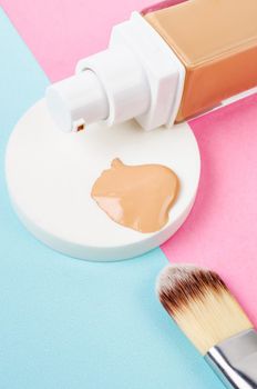 Liquid foundation makeup with brush and sponge on beautiful background.