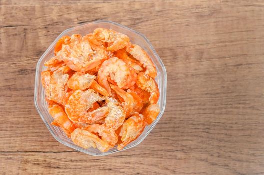 dried shrimp or dried salted prawn in cup on wooden background.